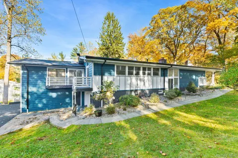 a view of a house with a yard and sitting area