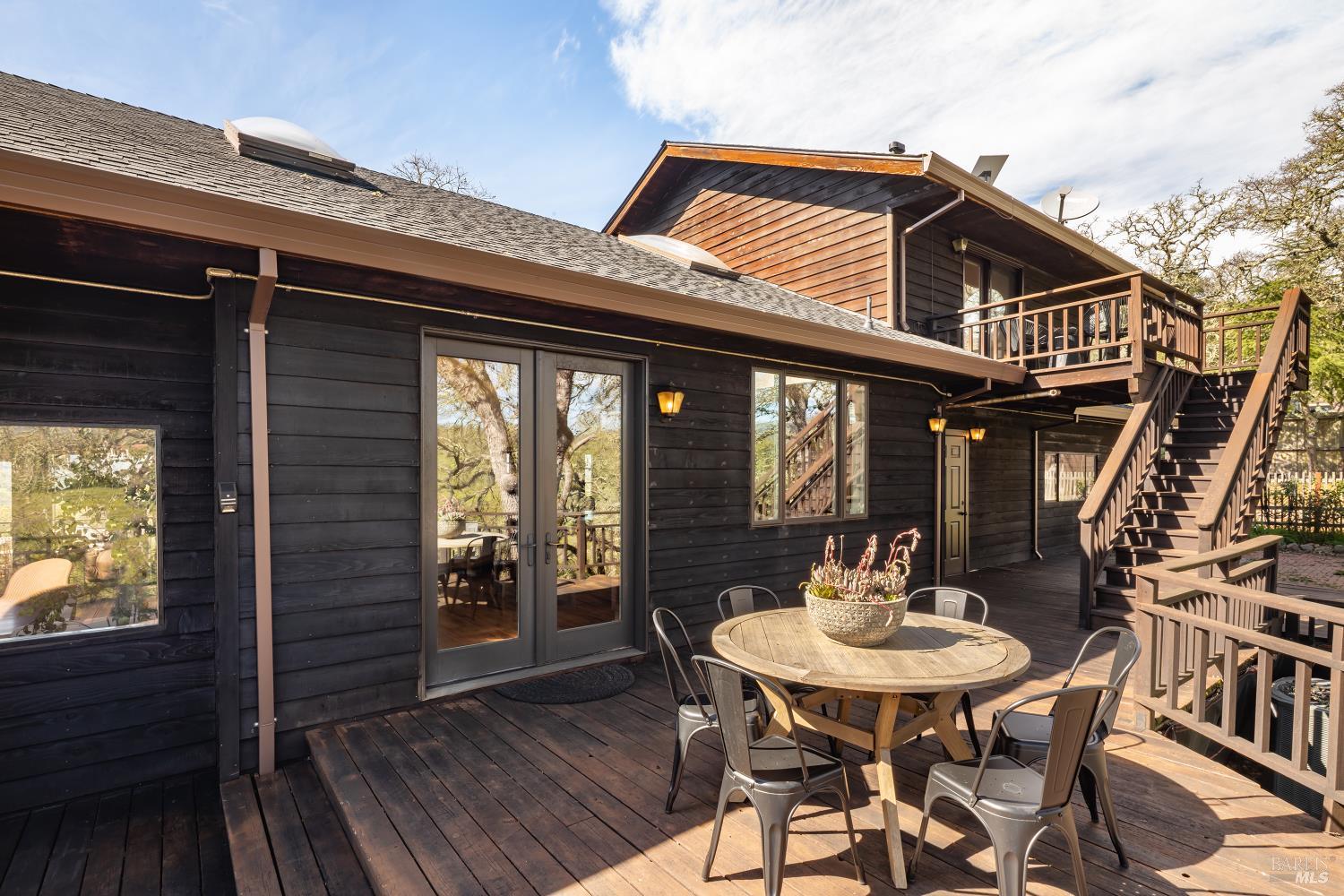 3460 Warm Springs Road Glen Ellen, CA 95442 - Photo 22 of 40 a roof deck with table and chairs and wooden floor