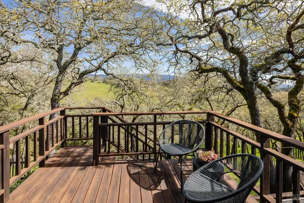 a view of balcony with wooden floor and fence