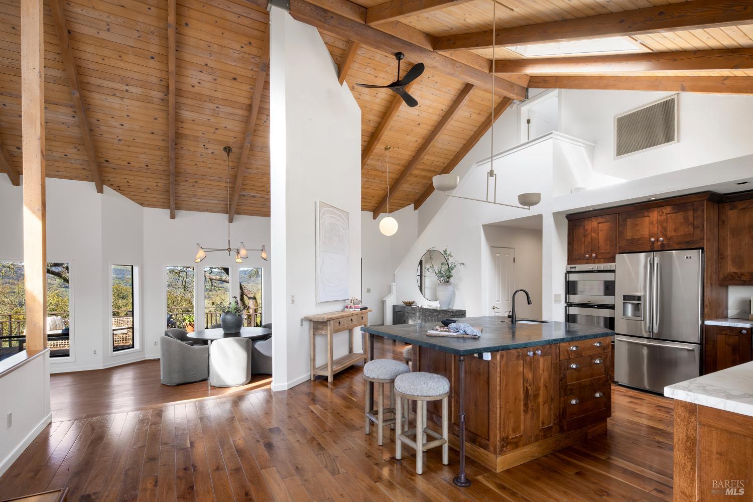 3460 Warm Springs Road Glen Ellen, CA 95442 - Photo 7 of 40 a kitchen with stainless steel appliances kitchen island granite countertop a table chairs and a refrigerator