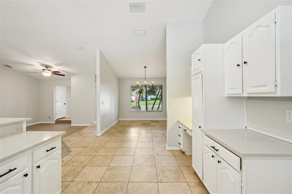 3109 Lake Valencia Lane East Palm Harbor, FL 34684 - Photo 14 of 59 a large white kitchen with granite countertop a sink