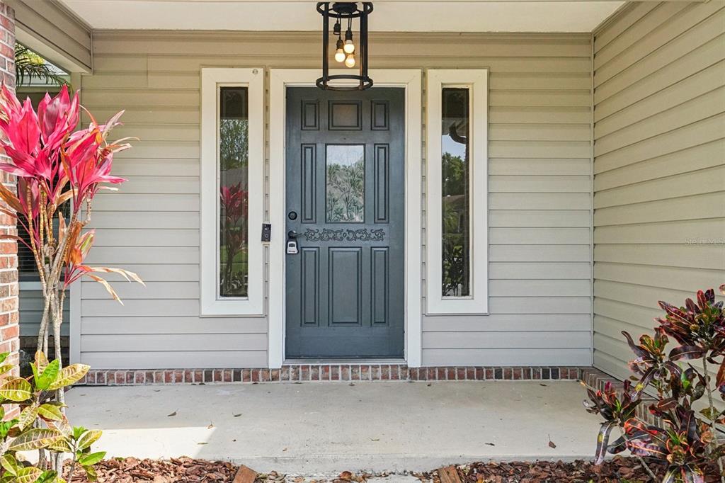 3109 Lake Valencia Lane East Palm Harbor, FL 34684 - Photo 2 of 59 a view of a house with a door and potted plants