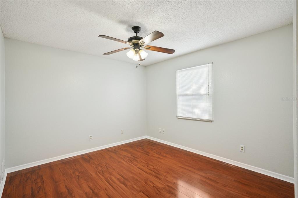 3109 Lake Valencia Lane East Palm Harbor, FL 34684 - Photo 24 of 59 an empty room with wooden floor fan and windows
