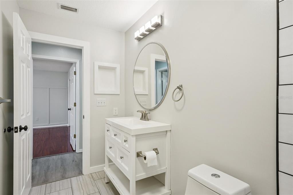 3109 Lake Valencia Lane East Palm Harbor, FL 34684 - Photo 27 of 59 a bathroom with a sink and a mirror