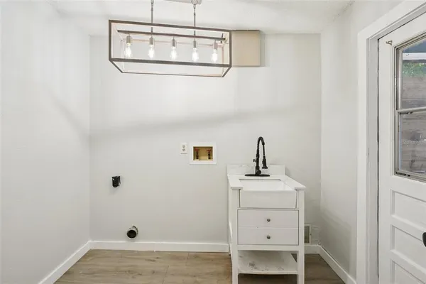 a view of a room with wooden floor and ceiling fan