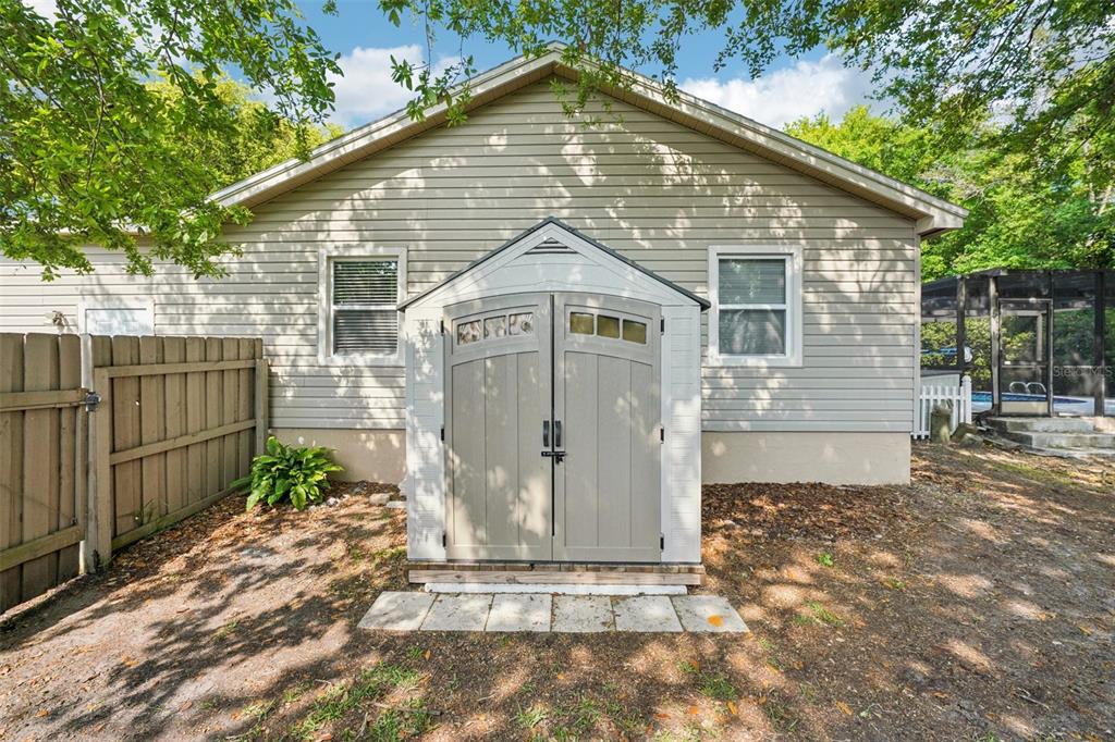 3109 Lake Valencia Lane East Palm Harbor, FL 34684 - Photo 40 of 59 a view of a small house with wooden fence