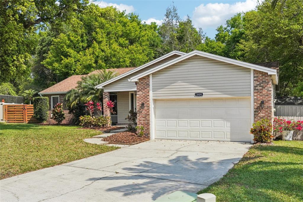 3109 Lake Valencia Lane East Palm Harbor, FL 34684 - Photo 46 of 59 a front view of house with yard and green space