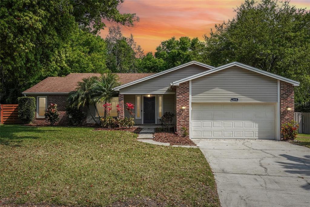 3109 Lake Valencia Lane East Palm Harbor, FL 34684 - Photo 57 of 59 a front view of a house with a yard and garage