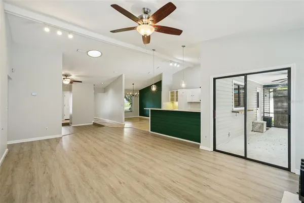 a view of empty room with wooden floor