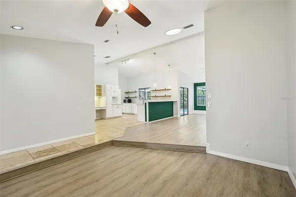 a kitchen with stainless steel appliances kitchen island granite countertop a sink and dishwasher a refrigerator with white cabinets