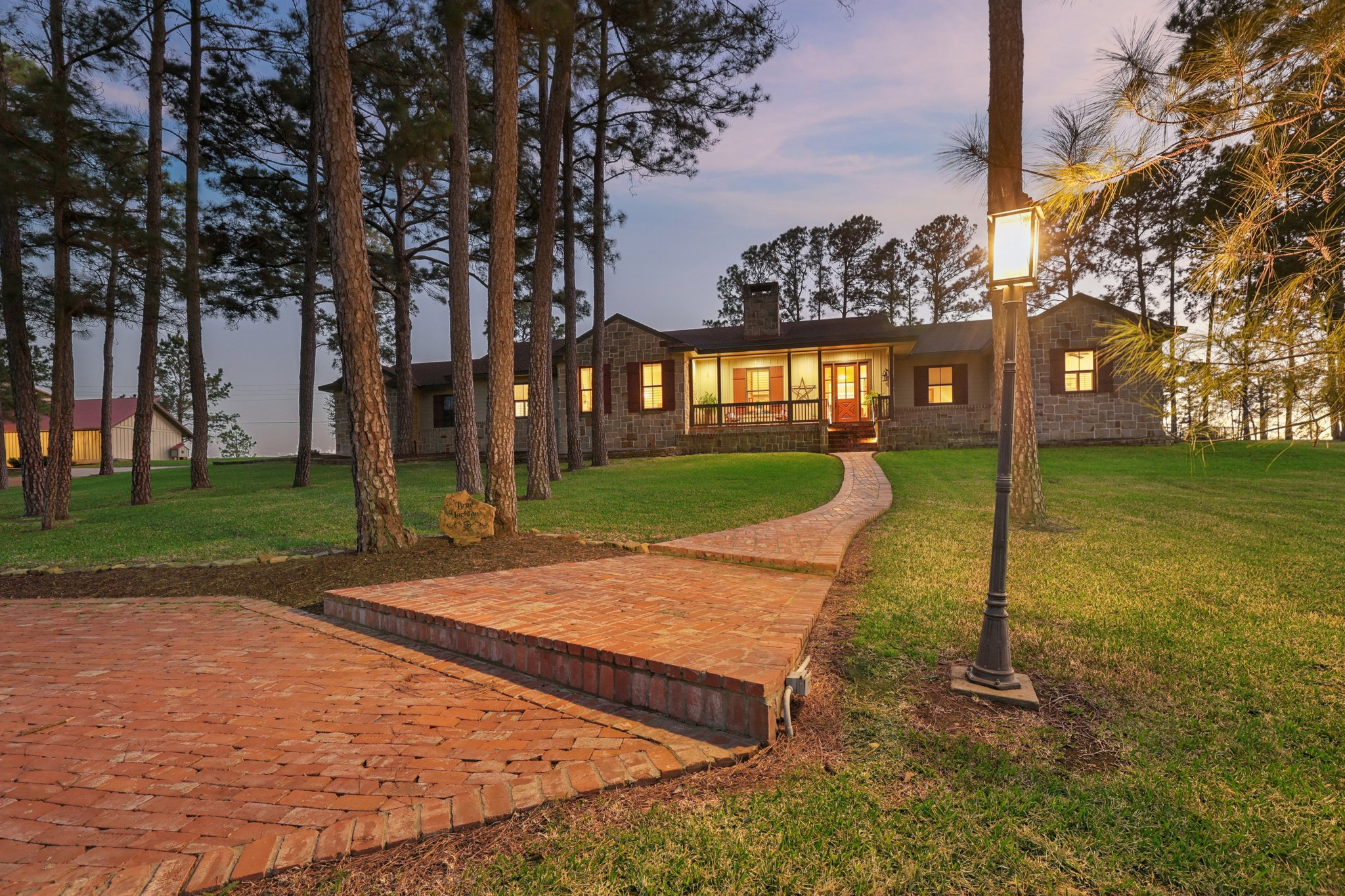 546 McAllister Road Bastrop, TX 78602 - Photo 9 of 40 Back of house at dusk with a patio area, a lawn, and a chimney