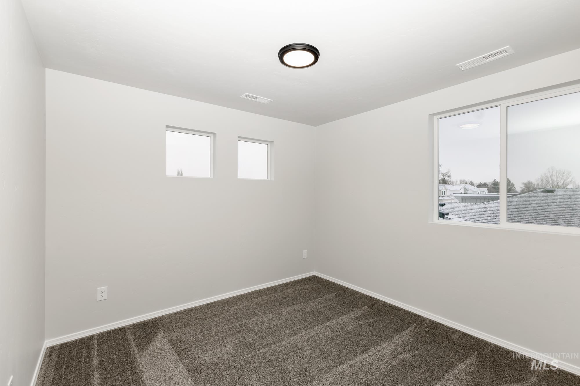 13712 Nisene Street Caldwell, ID 83607 - Photo 15 of 23 Unfurnished room featuring dark colored carpet and baseboards