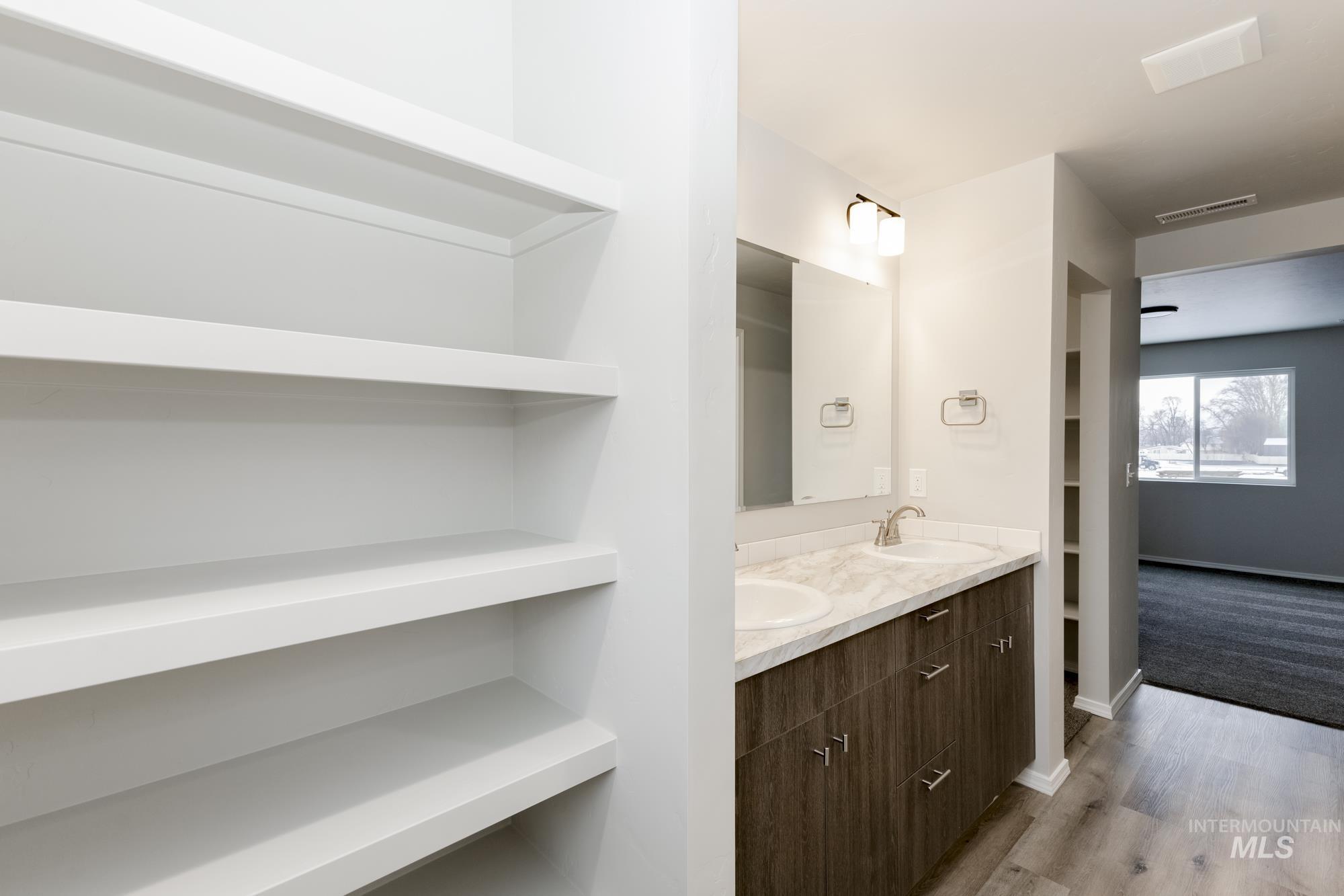 13712 Nisene Street Caldwell, ID 83607 - Photo 21 of 23 Bathroom with double vanity, light wood-type flooring, and built in features