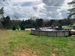 a view of a swimming pool with a yard