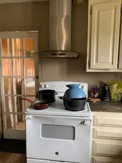 a view of kitchen with stainless steel appliances granite countertop a stove and a refrigerator