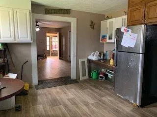 a view of hallway with wooden floor and furniture