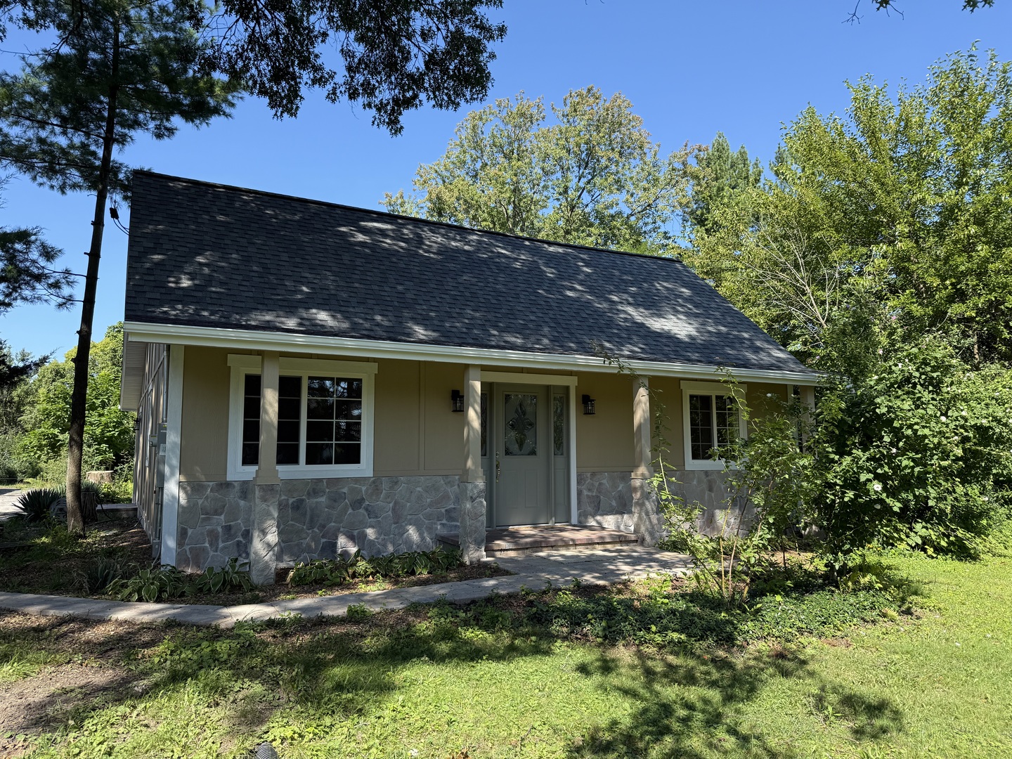 a front view of a house with a yard garage and outdoor seating