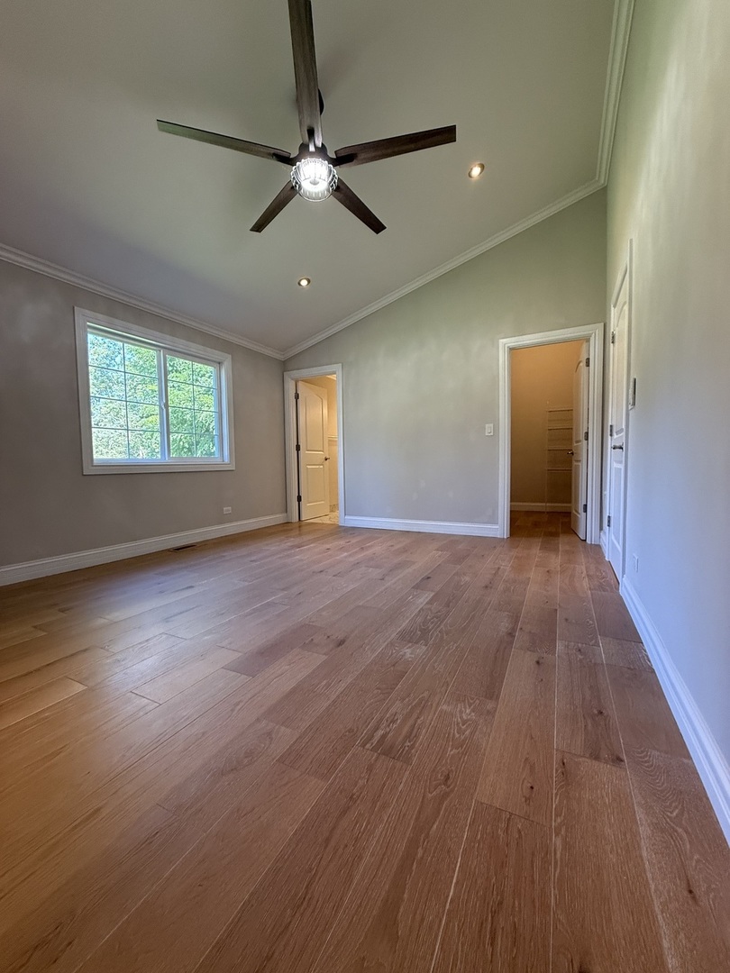 8144 Sunset Road Willowbrook, IL 60527 - Photo 5 of 8 a view of an empty room with wooden floor and a window