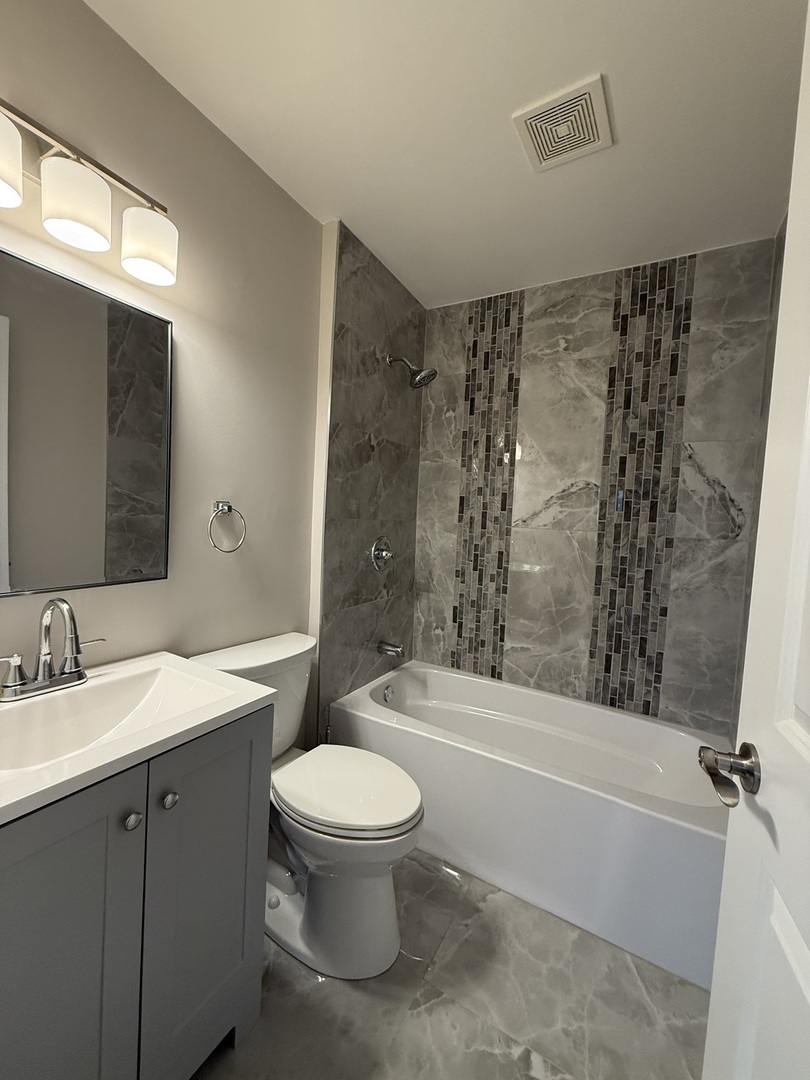 8144 Sunset Road Willowbrook, IL 60527 - Photo 6 of 8 a bathroom with a sink toilet and shower