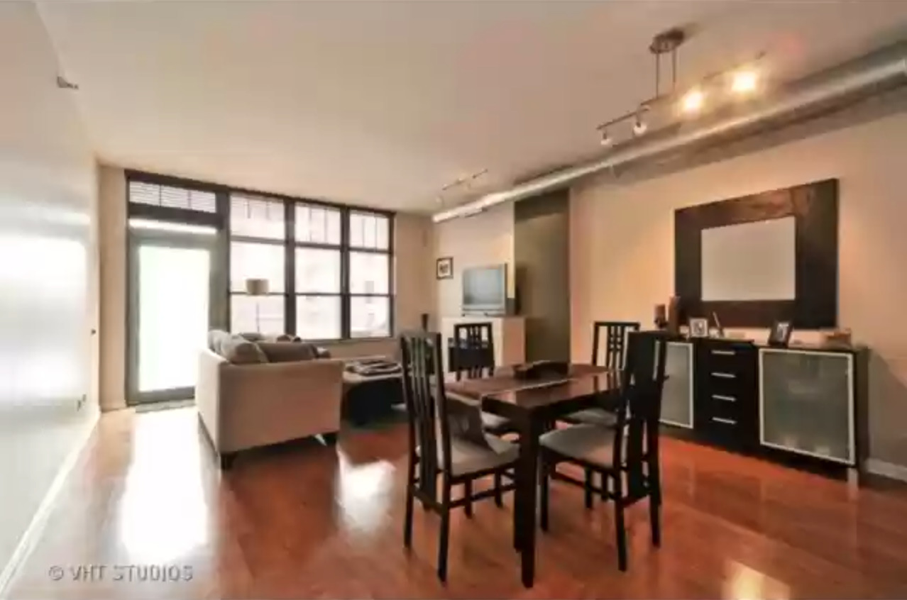 1200 West Monroe Street, Unit 603 Chicago, IL 60607 - Photo 4 of 11 a view of a dining room with furniture window and wooden floor