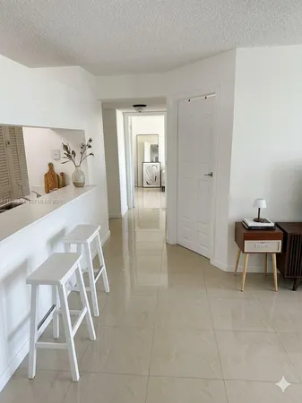 a view of a room that has a table and chairs in it