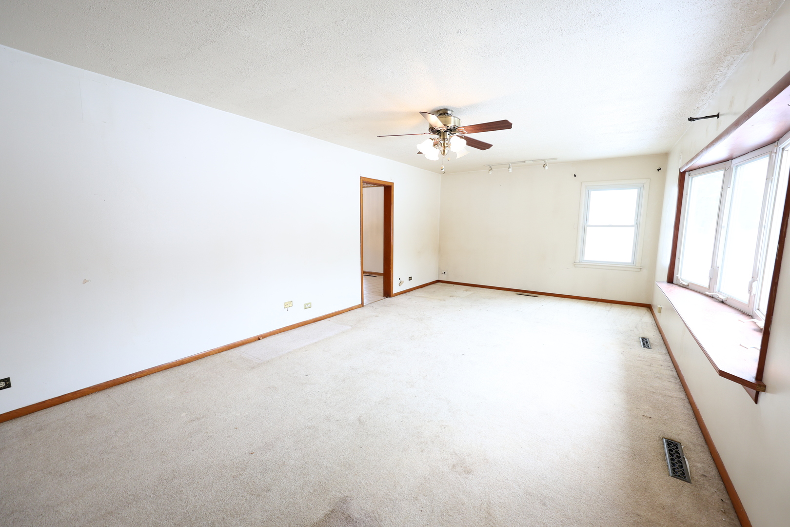 6837 113th Street Worth, IL 60482 - Photo 2 of 17 an empty room with windows and fan