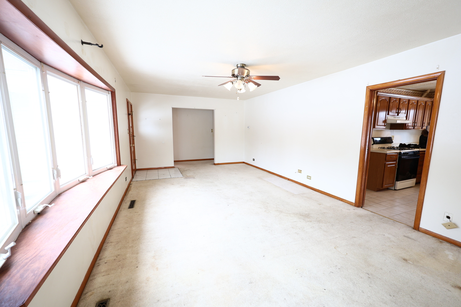 6837 113th Street Worth, IL 60482 - Photo 3 of 17 wooden floor in an empty room with a window
