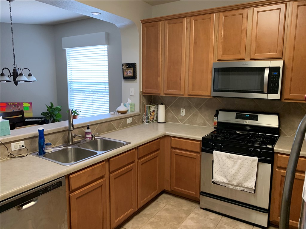 1900 Scofield Ridge Parkway, Unit 1202 Austin, TX 78727 - Photo 4 of 18 Plentiful cabinet storage and countertop space. Opens to dining area