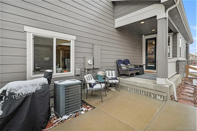 a view of a patio with couches table and chairs and potted plants