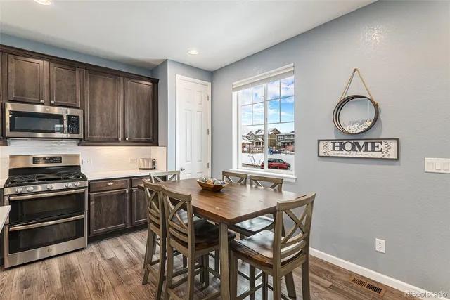 a kitchen with stainless steel appliances a stove a sink and a refrigerator