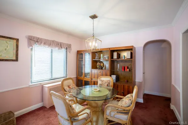 a dining room with furniture a chandelier and wooden floor