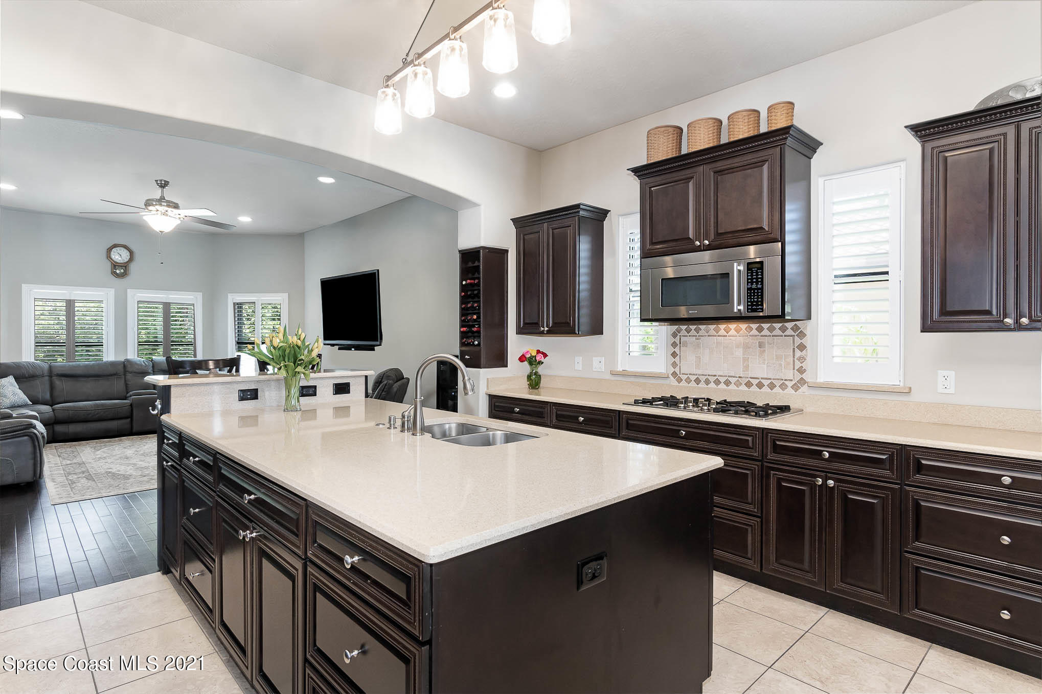4175 Waterloo Place Melbourne, FL 32940 - Photo 16 of 49 a kitchen with a sink stove top oven and microwave