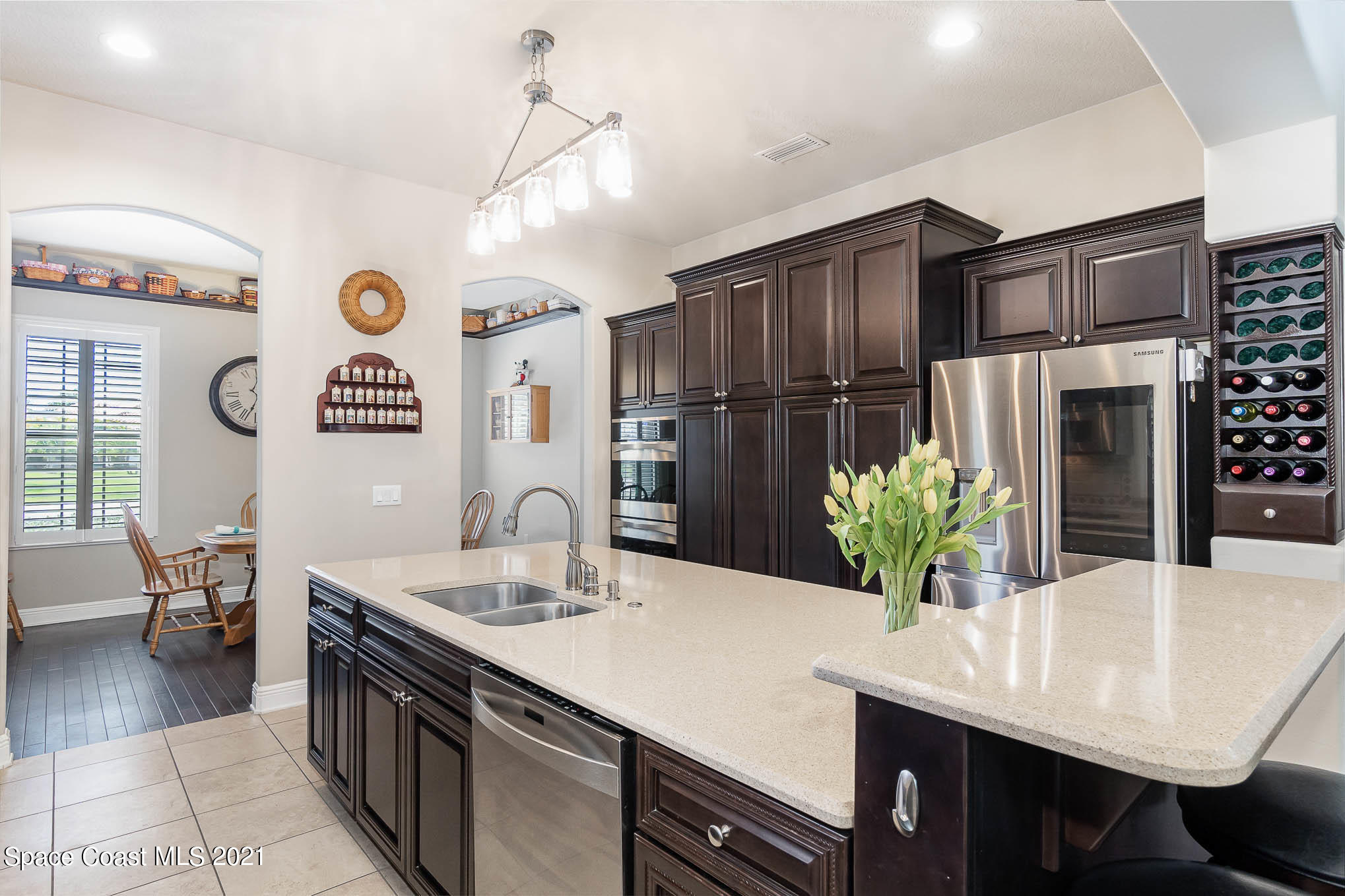 4175 Waterloo Place Melbourne, FL 32940 - Photo 17 of 49 a kitchen with stainless steel appliances kitchen island granite countertop a table chairs and a refrigerator