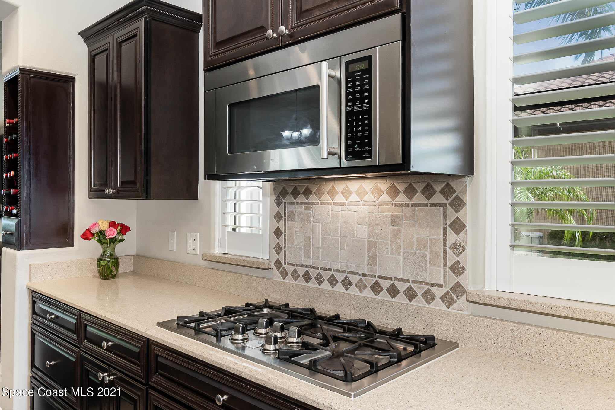 4175 Waterloo Place Melbourne, FL 32940 - Photo 18 of 49 a kitchen with a stove and a microwave