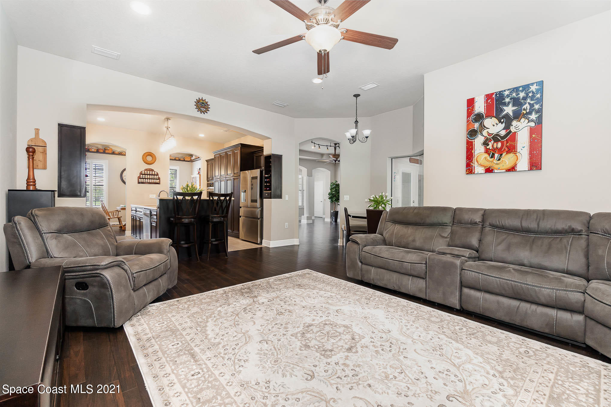 4175 Waterloo Place Melbourne, FL 32940 - Photo 21 of 49 a living room with furniture and a chandelier