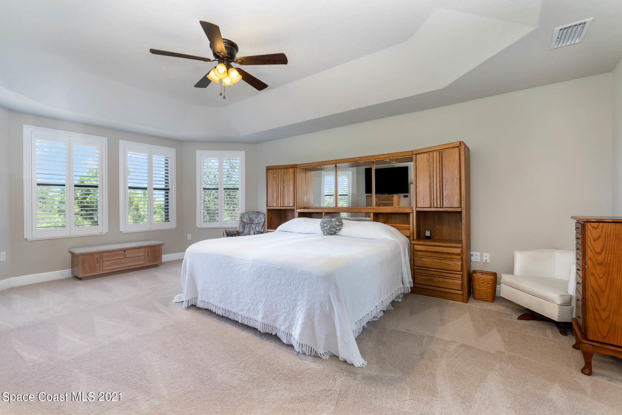 4175 Waterloo Place Melbourne, FL 32940 - Photo 23 of 49 a spacious bedroom with a bed and a large window
