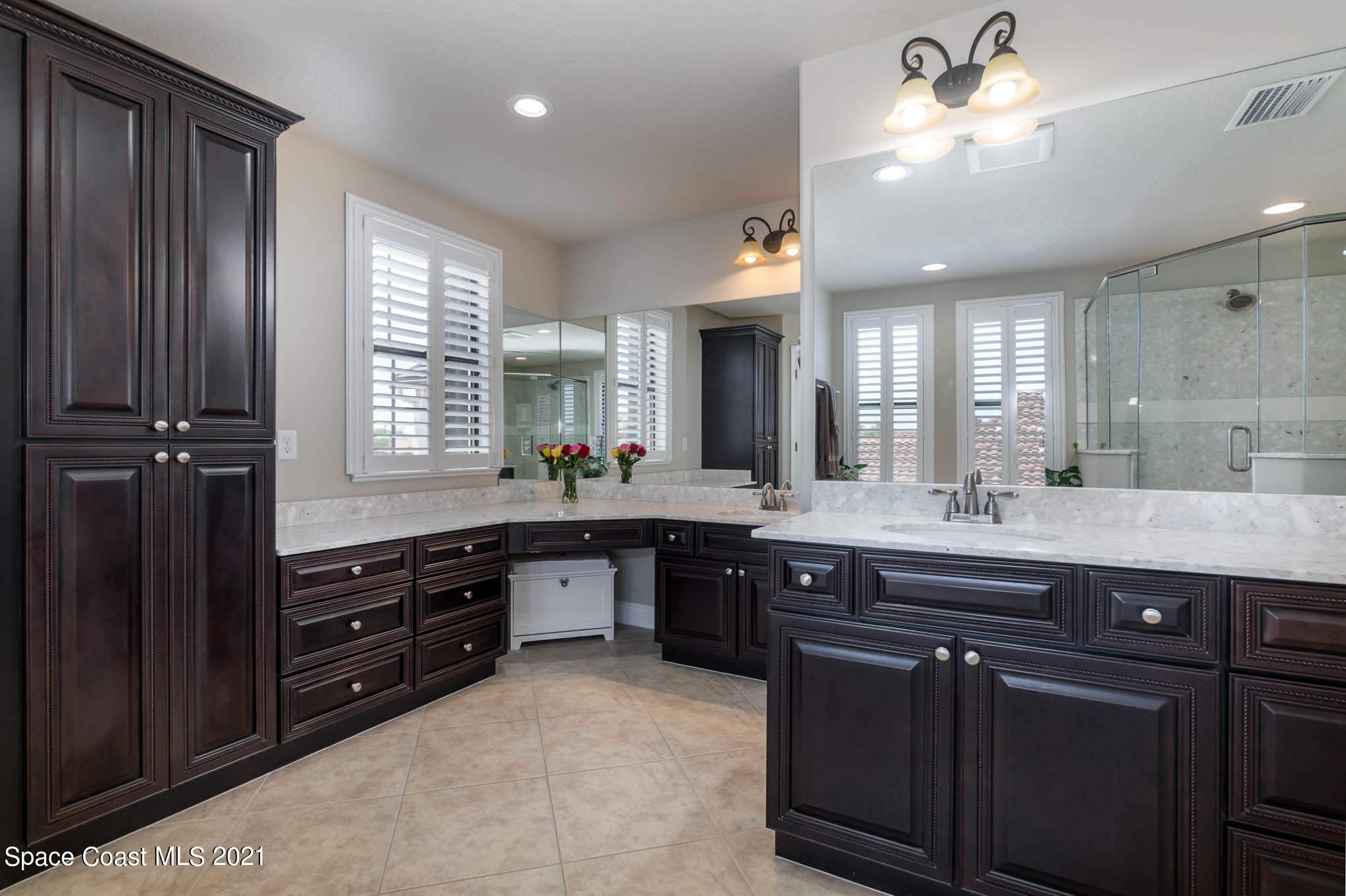 4175 Waterloo Place Melbourne, FL 32940 - Photo 26 of 49 a large kitchen with kitchen island granite countertop a sink dishwasher a stove and white cabinets