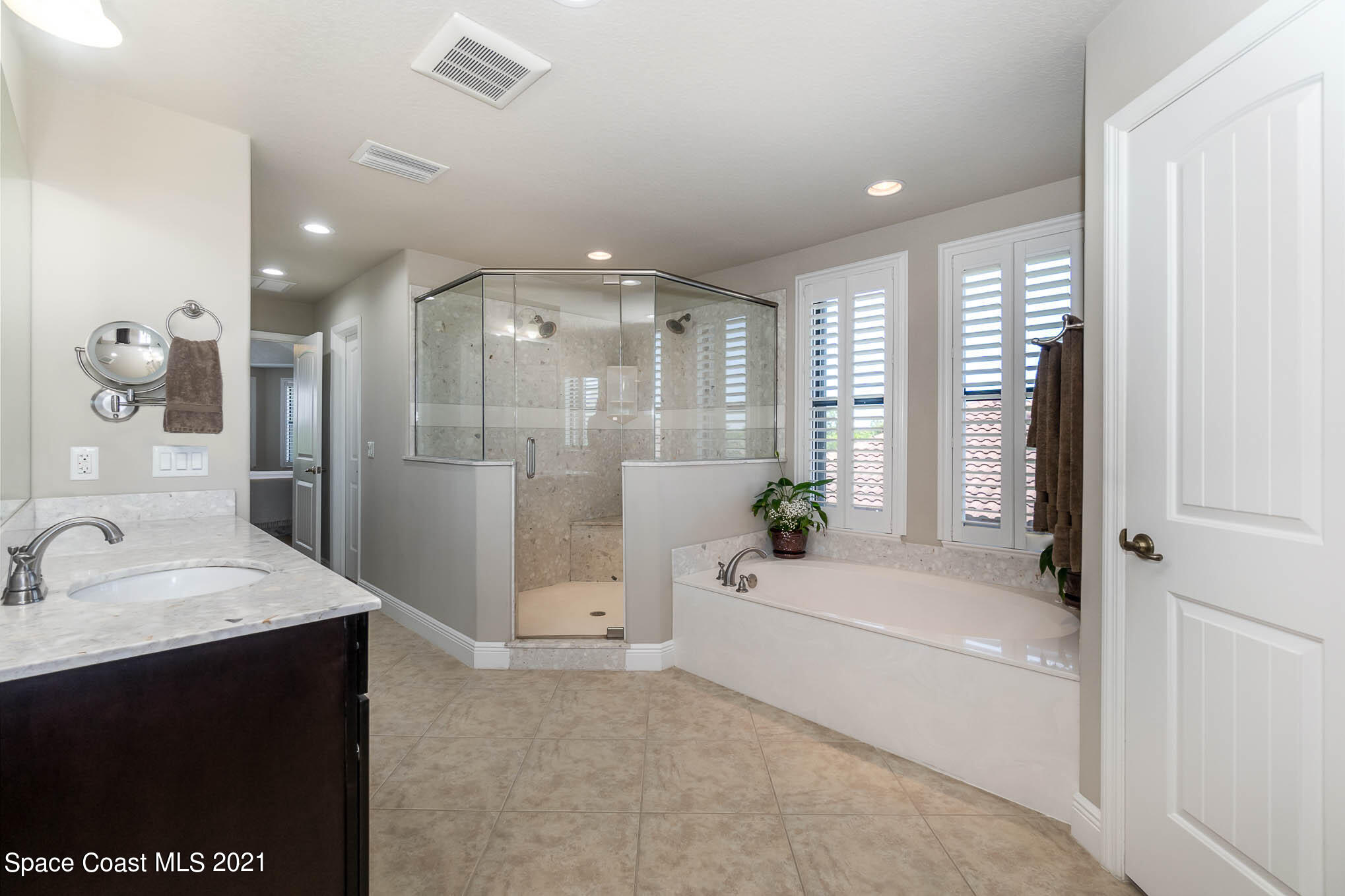 4175 Waterloo Place Melbourne, FL 32940 - Photo 28 of 49 a bathroom with a bathtub shower sink and mirror
