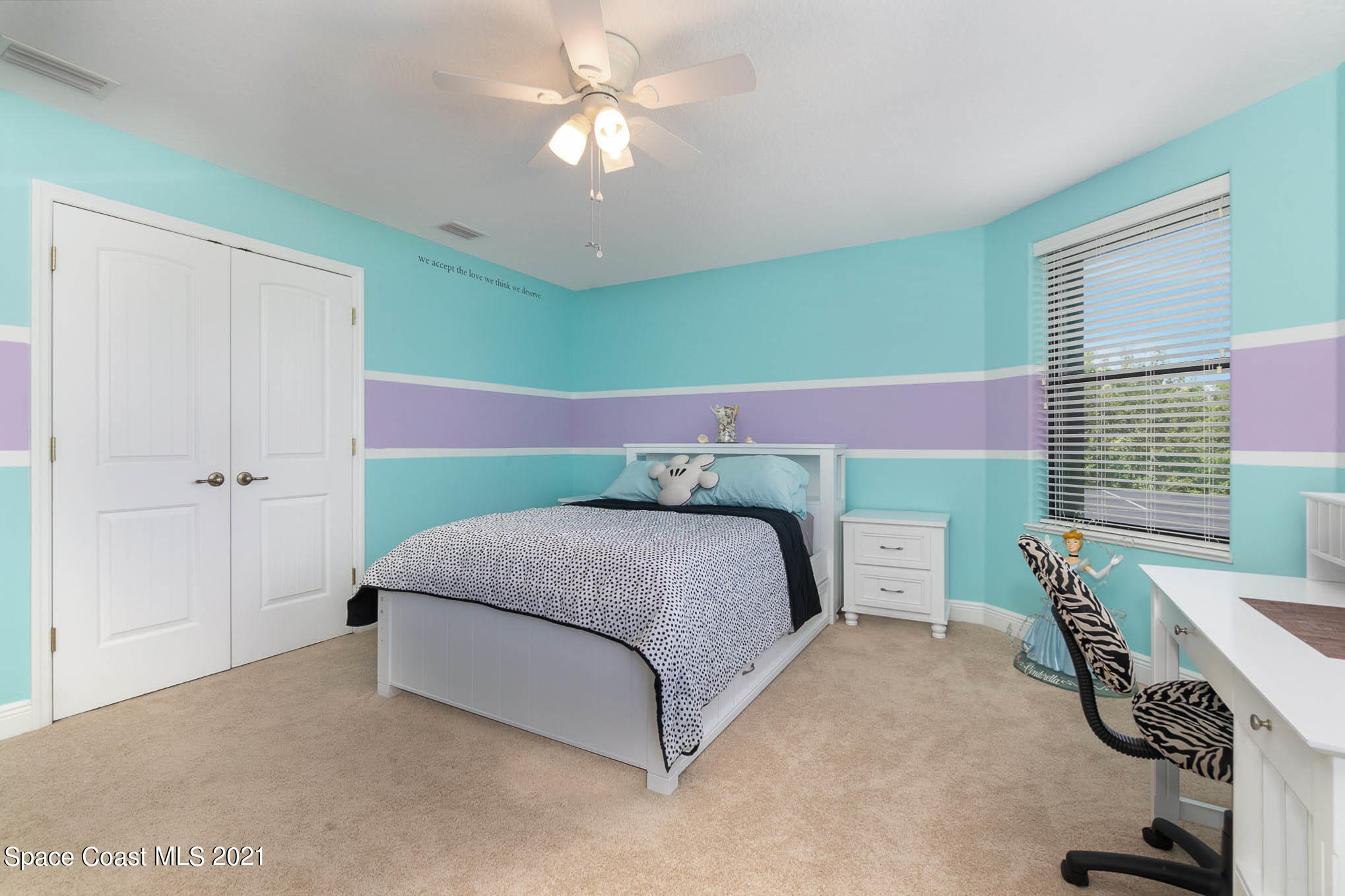 4175 Waterloo Place Melbourne, FL 32940 - Photo 30 of 49 a bedroom with a bed and a chandelier