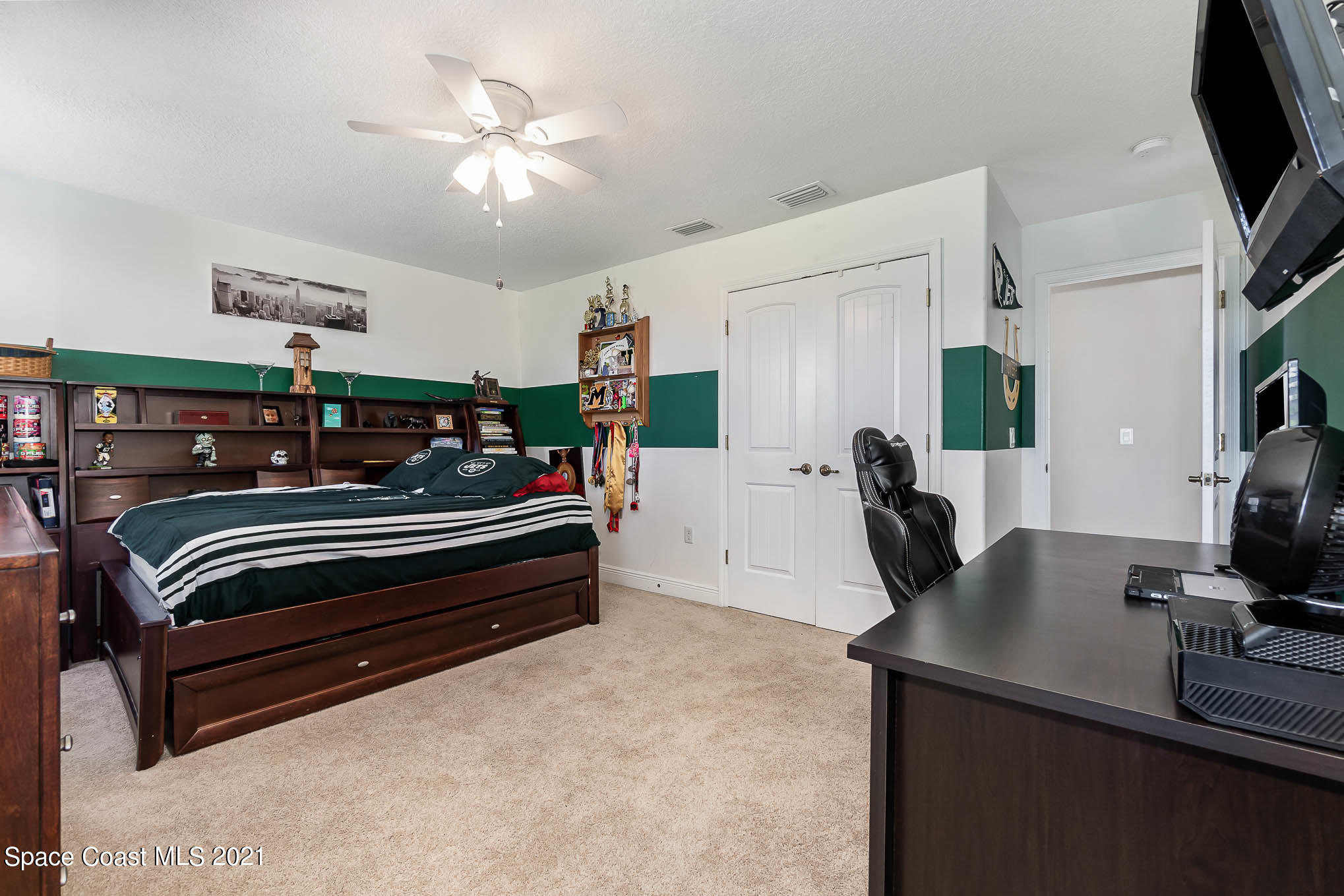 4175 Waterloo Place Melbourne, FL 32940 - Photo 33 of 49 a bedroom with furniture and a flat screen tv