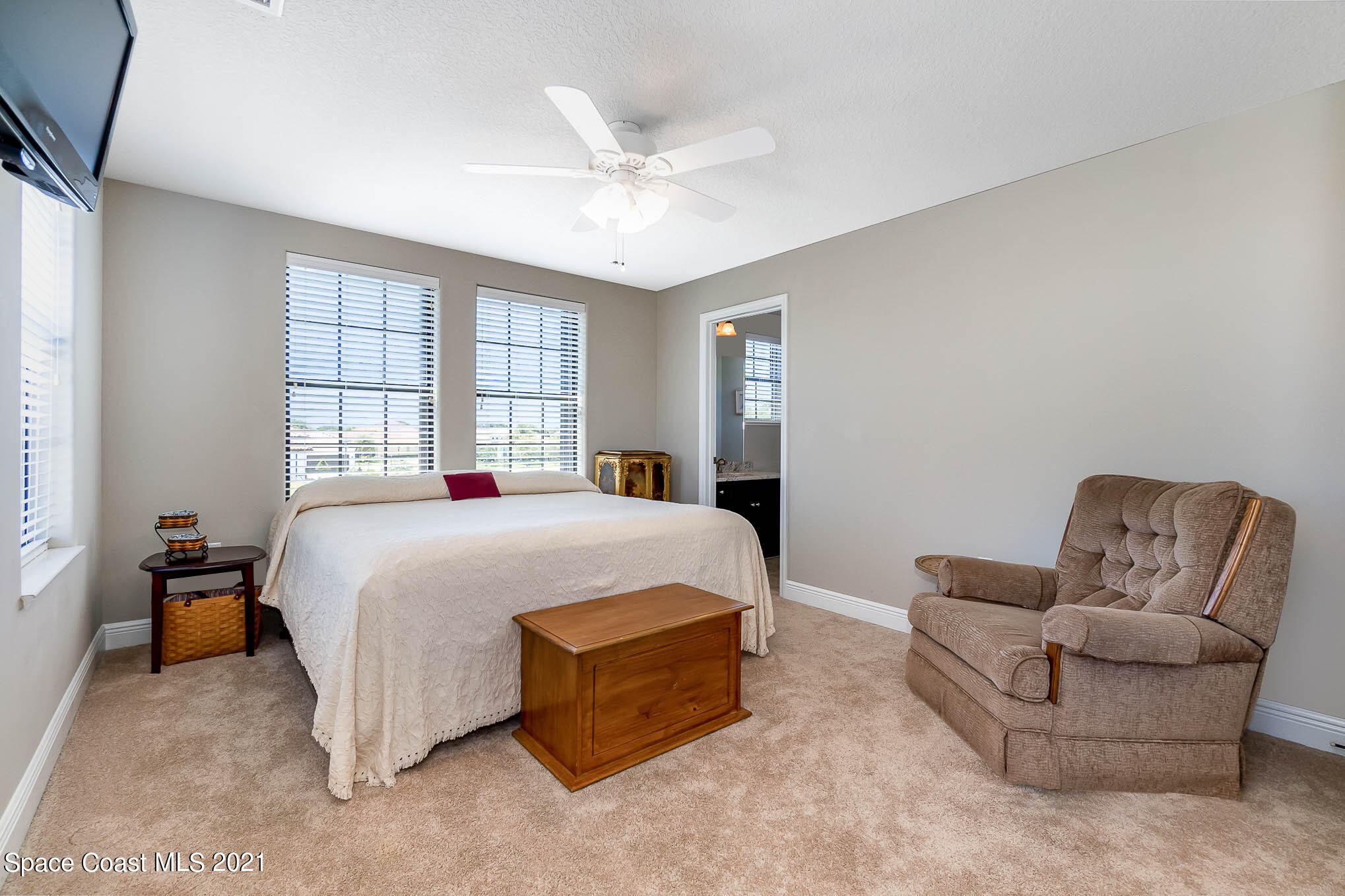 4175 Waterloo Place Melbourne, FL 32940 - Photo 35 of 49 a spacious bedroom with a bed and window