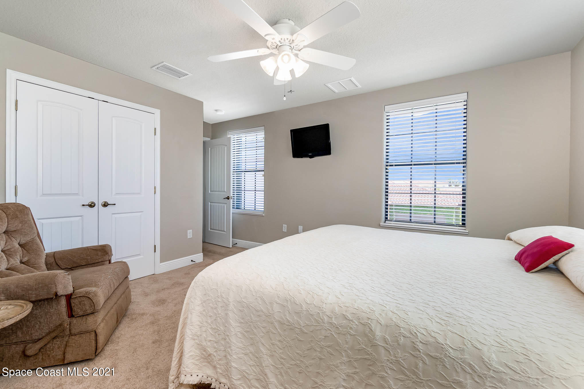 4175 Waterloo Place Melbourne, FL 32940 - Photo 36 of 49 a spacious bedroom with a bed and a couch