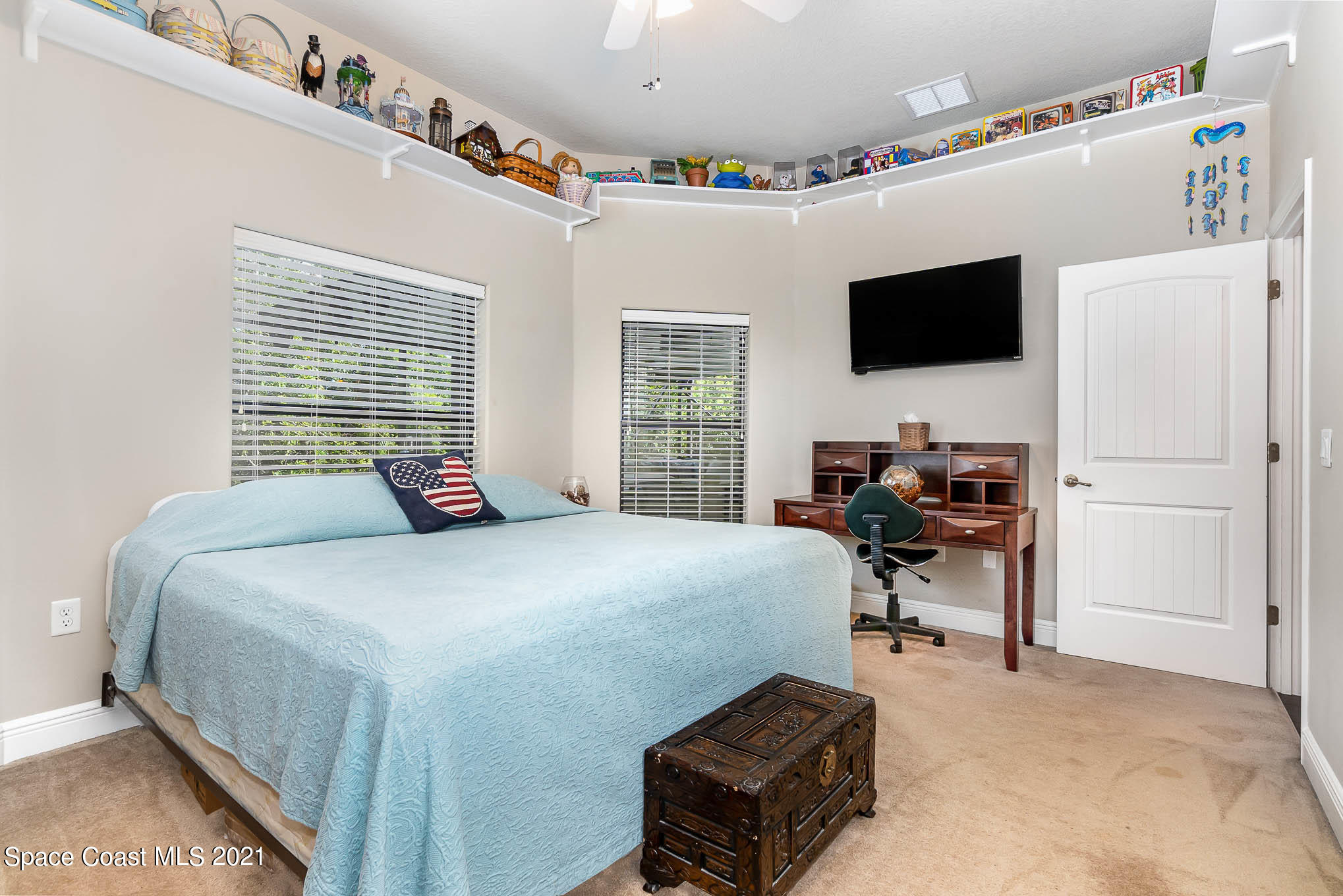 4175 Waterloo Place Melbourne, FL 32940 - Photo 40 of 49 a bedroom with a bed a flat screen tv and a dresser
