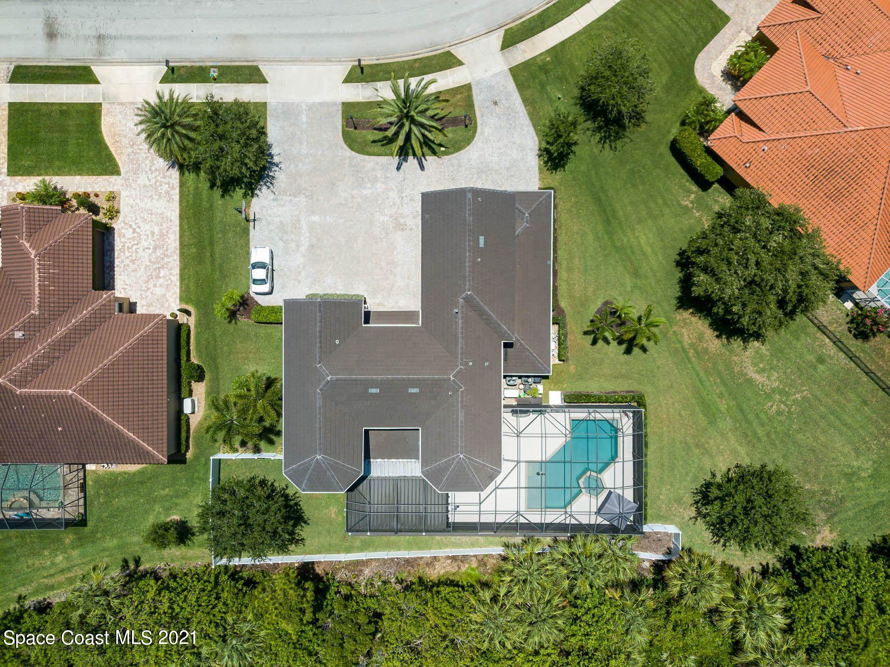 4175 Waterloo Place Melbourne, FL 32940 - Photo 5 of 49 an aerial view of a house with yard swimming pool and outdoor seating