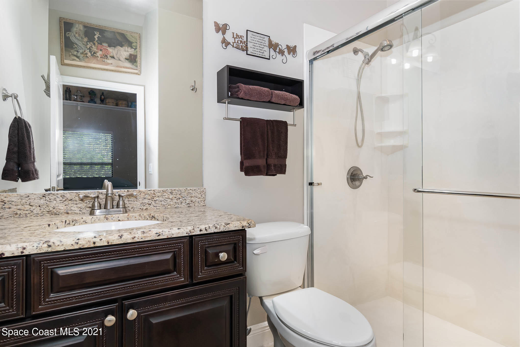 4175 Waterloo Place Melbourne, FL 32940 - Photo 41 of 49 a bathroom with a granite countertop sink toilet and shower
