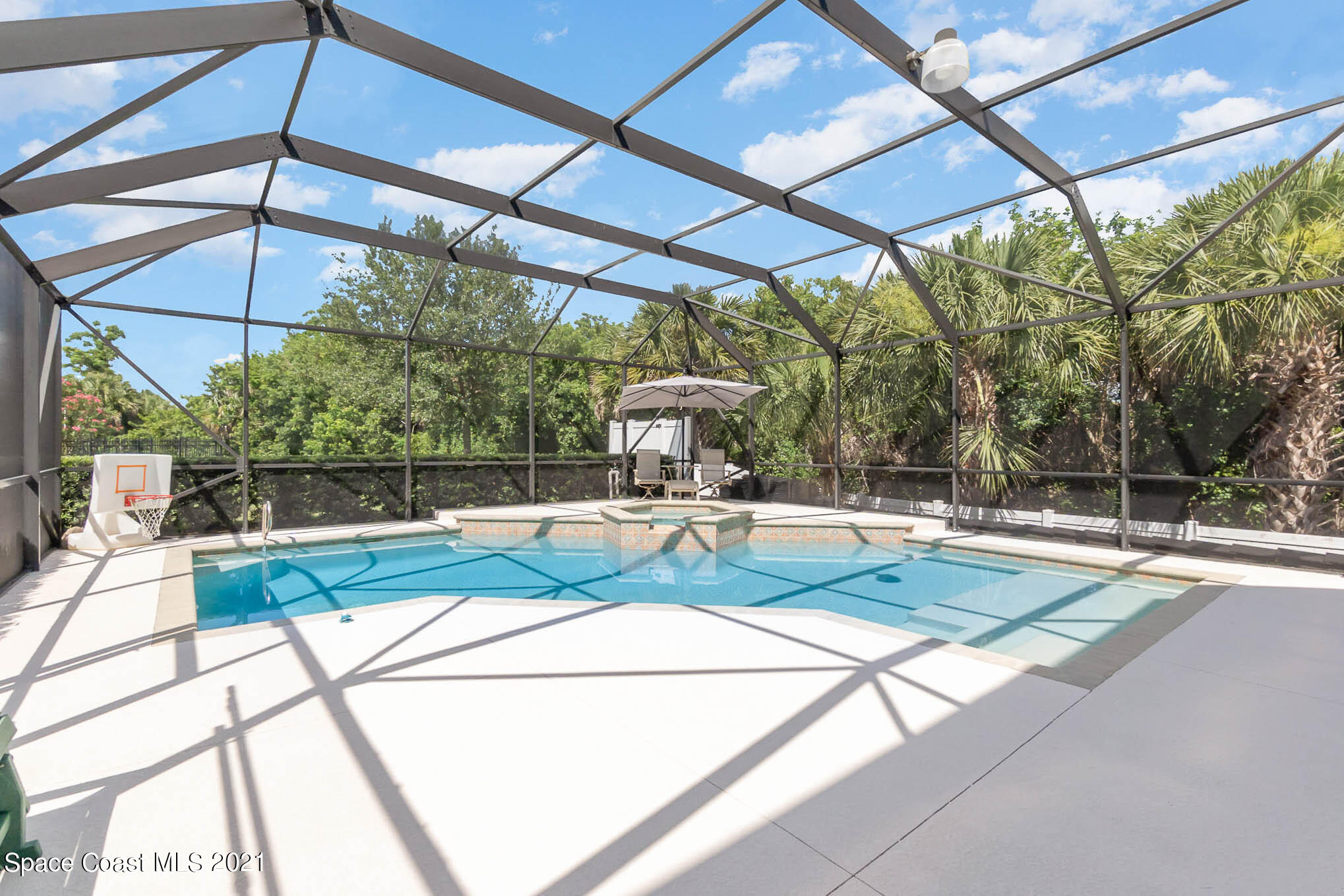 4175 Waterloo Place Melbourne, FL 32940 - Photo 45 of 49 a view of a patio with a table and chairs under an umbrella