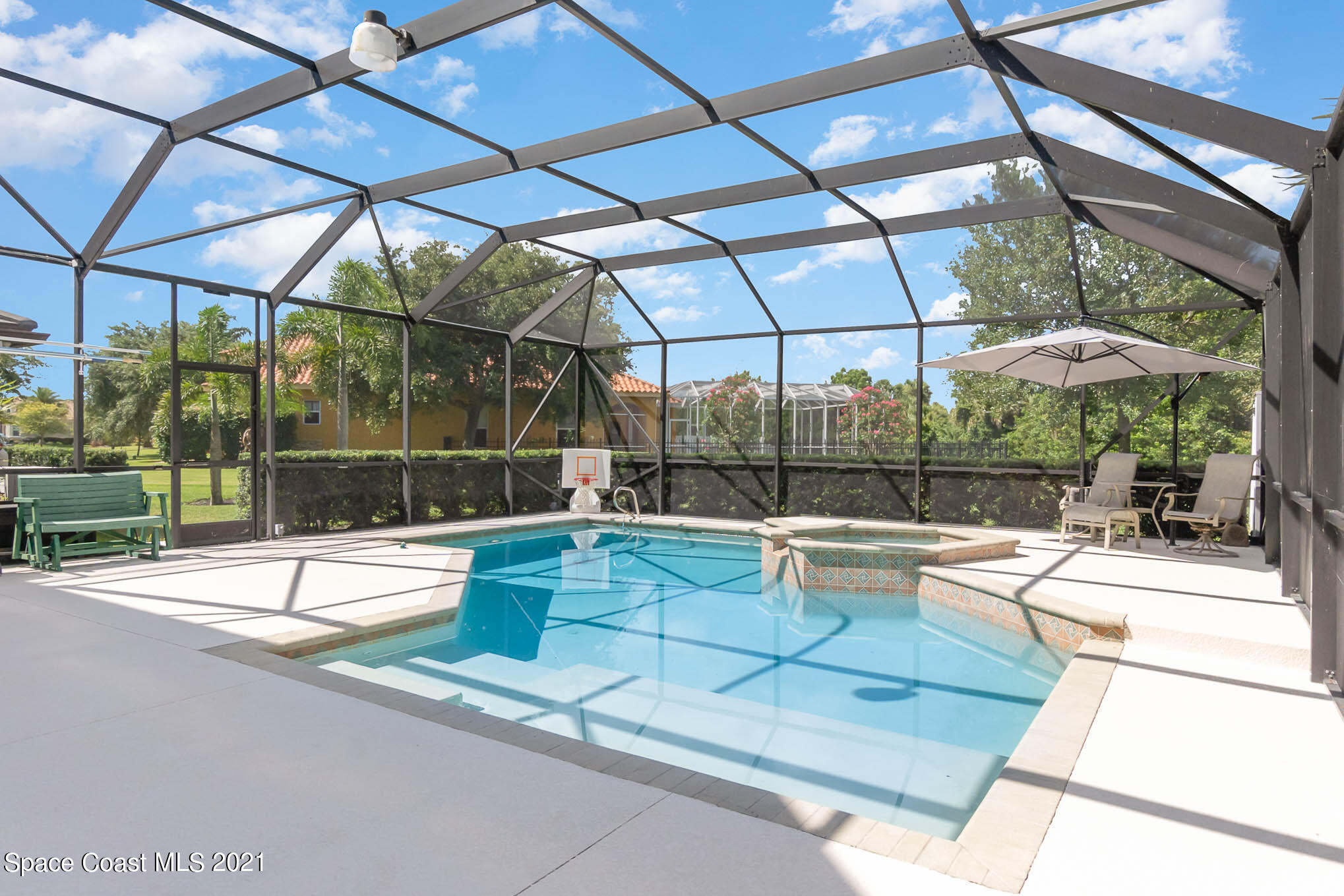 4175 Waterloo Place Melbourne, FL 32940 - Photo 8 of 49 a view of a patio with a dining table and chairs under an umbrella