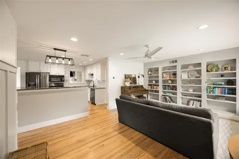 a living room with furniture window and wooden floor