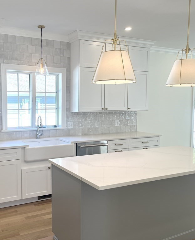 18 Libby Avenue Reading, MA 01867 - Photo 14 of 23 a kitchen with a sink a window and a counter top space