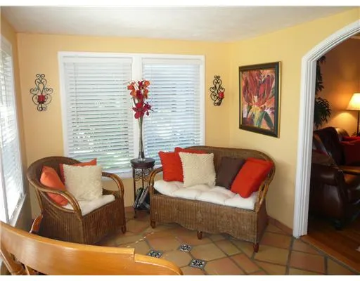 a living room with furniture and painting on the wall